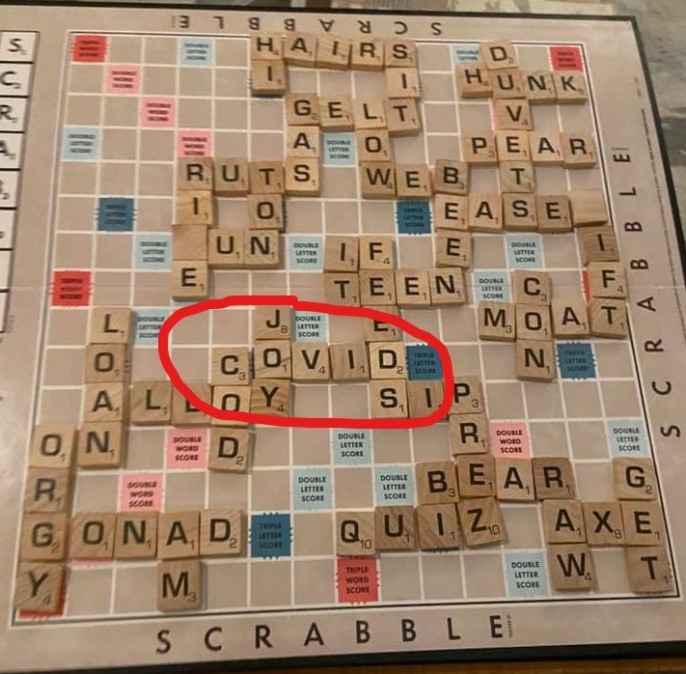 covid spelled out on scrabble board
