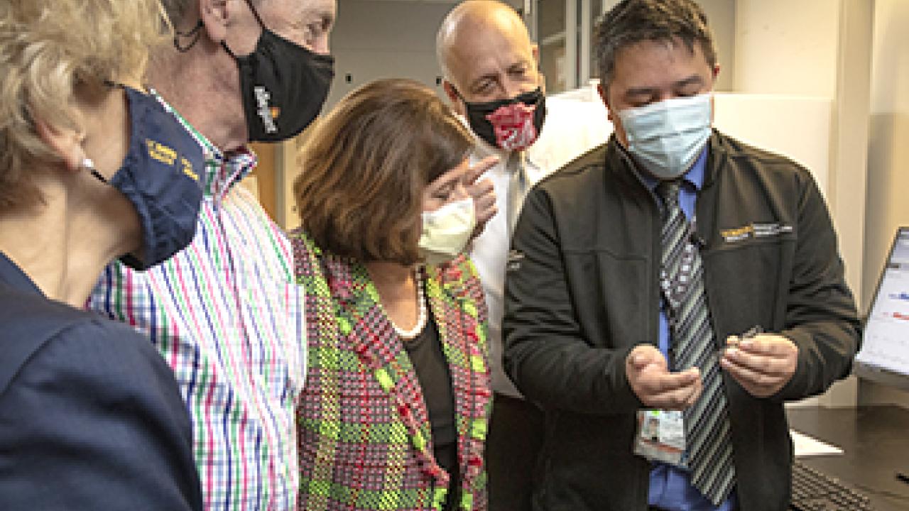 group of people looking at device in hand